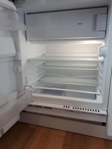 an empty refrigerator with its door open in a kitchen at "Au pied du Beffroi" - Superbe emplacement in Arras