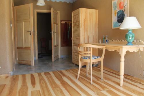 a room with a desk and a table with a lamp at Szwajcaria Mazurska in Zawady Oleckie