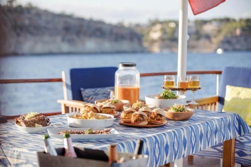 a table with food on it with a view of the water at Don Maximo in Vigo