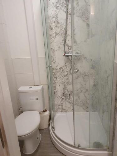 a bathroom with a toilet and a glass shower at Wite in Colchester