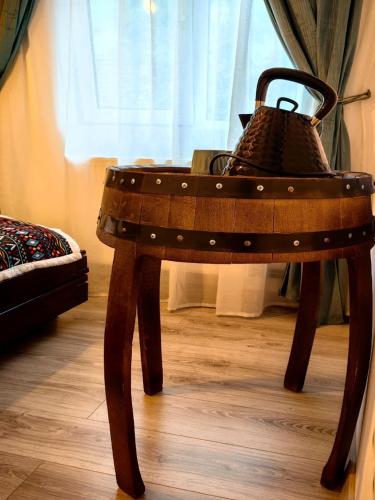 a wooden table with a basket on top of it at Voinescu House - Natural Living & Eating in Şimon