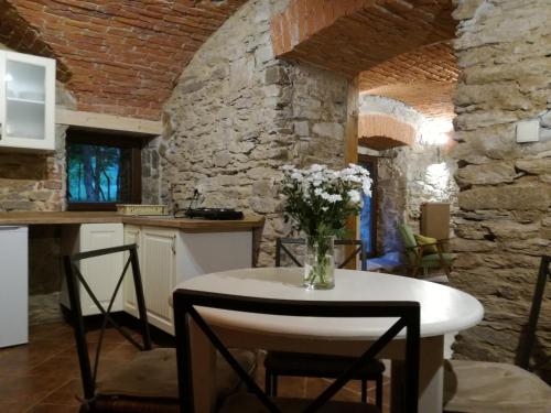 a kitchen with a table with a vase of flowers on it at Niezapominajka in Kletno