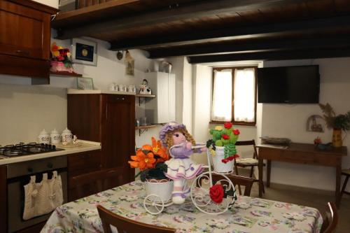 a kitchen with a table with flowers on it at Twins' Historical Apartment in Trevi