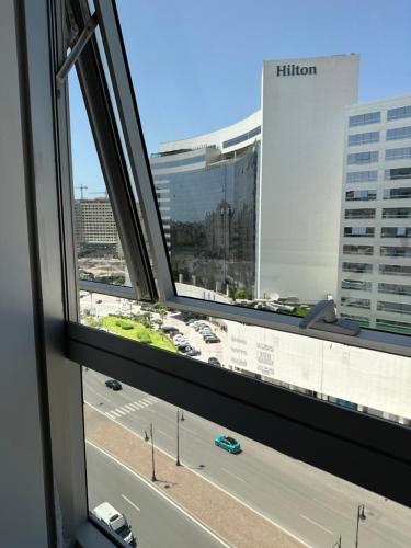 a view of a city street from a window at luxury apartment in City Center Hilton in Tangier