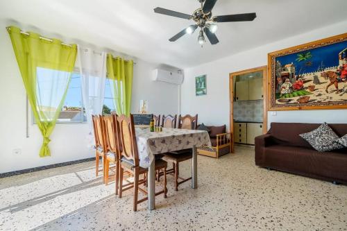 a dining room with a table and chairs and a couch at Can Sant Joan in Alcanar