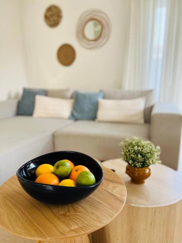 a bowl of fruit on a table in a living room at Ons Maashuisje in Maaseik