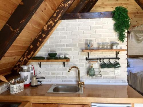 a kitchen with a sink and a brick wall at Tenora in Rize