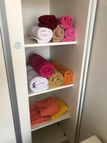 a towel rack with colorful towels in it at Cozy studio, Center, Sea view in Baku