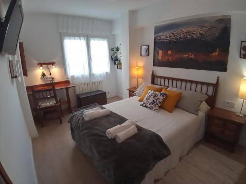 a bedroom with a large bed with two pillows on it at MERINDADES AMAZUL CORZO - Apartamento Turístico - Medina de Pomar in Medina de Pomar
