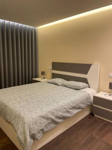 a bedroom with a large bed and a window at Casas da Veiga in Braga