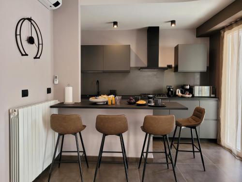 a kitchen with a counter and bar stools at Al Dolce Vita in Stresa