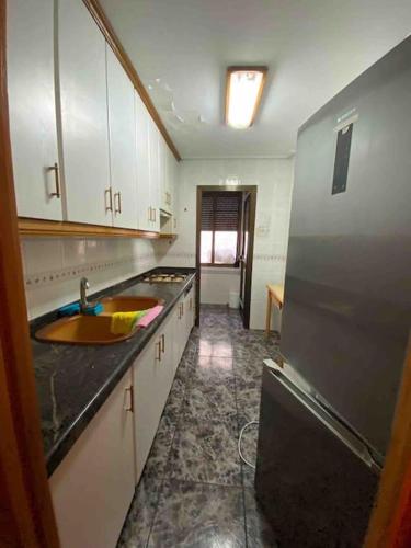 uma cozinha com um lavatório e um frigorífico em Appartement in spanje em Vall de Uxó