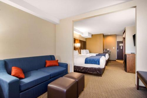 a hotel room with a couch and a bed at Comfort Inn & Suites in Medicine Hat