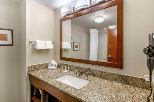 a bathroom with a sink and a large mirror at Comfort Inn & Suites Christiansburg I-81 in Christiansburg