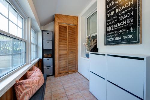 a home office with a chalkboard on the wall at Charming Beach Retreat in Toronto