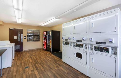 a laundry room with white cabinets and a soda machine at Extended Stay America Suites - Akron - Copley - East in Copley