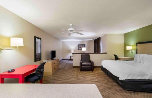 a hotel room with a bed and a red desk at Extended Stay America Suites - Kansas City - Overland Park - Quivira Rd in Lenexa