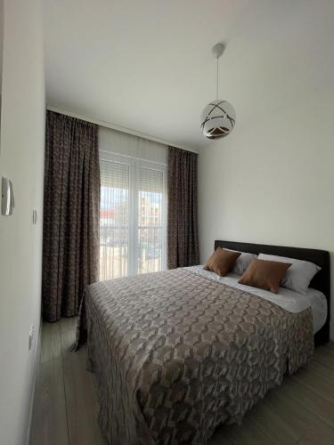 a bedroom with a large bed and a window at Wistaria Hill in Ðenovići