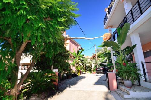 a street with a tree and a building at Villa Ektoras by EY Villas in Parga