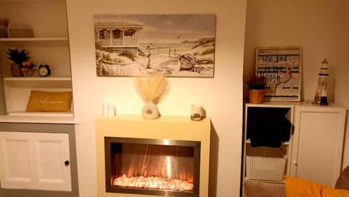 a fireplace in a living room with a fire place at Private room with Netflix in Litherland
