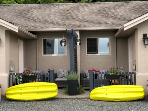 a house with two yellow ottomans in front of it at Qualicum Breeze Beach Resort in Qualicum Beach