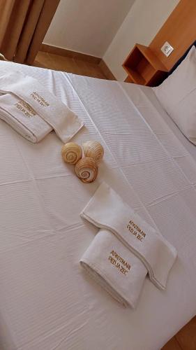 a bed with white towels and rolls on it at Villa Pedja Zec in Budva