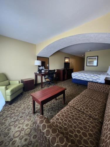 Habitación de hotel con cama y escritorio en Highland Suites Extended Stay, en Minot