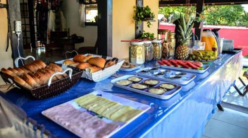 a buffet of food on a blue table at Bela Mare Buzios in Búzios