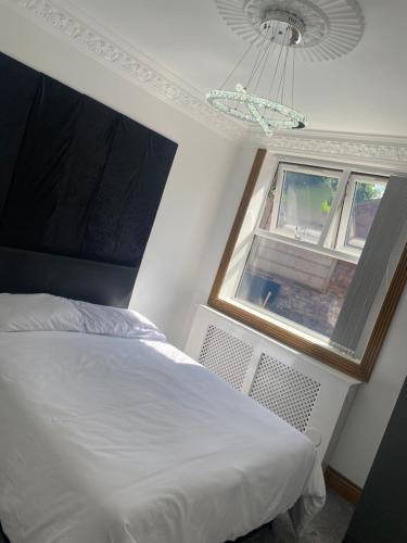 ein Schlafzimmer mit einem weißen Bett und einem Fenster in der Unterkunft Pure luxury APT2 in Wolverhampton