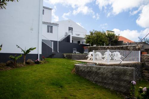 a white bench in the yard of a house at Oásis Fonte Grande in Santo António