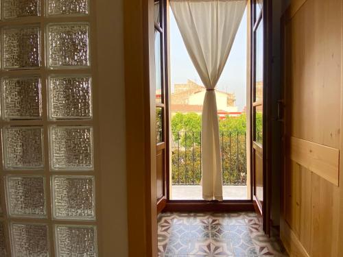 an open door with a view of a balcony at Guest House Baruffi in Carloforte
