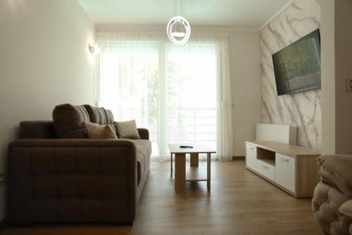 a living room with a couch and a table at GOLDEN VIEW Sokobanja in Soko Banja