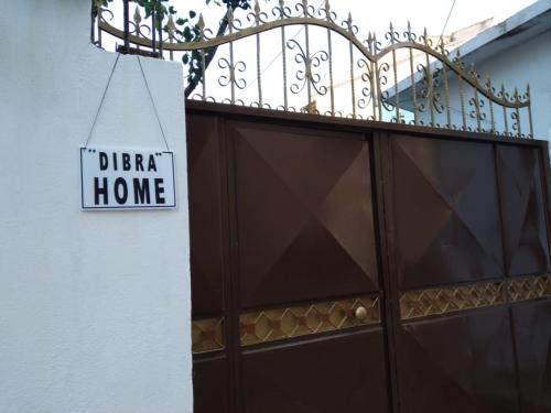 a sign that reads deficit home next to a building at Dibra Home near City Center of Shkodra in Shkodër