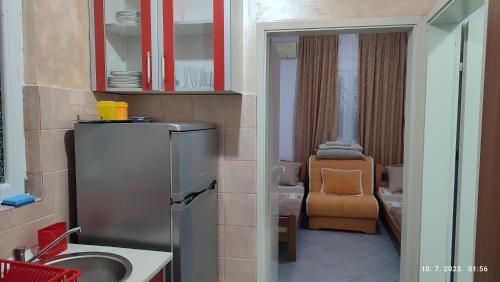 a small kitchen with a sink and a refrigerator at Pejovic Guest House in Sutomore