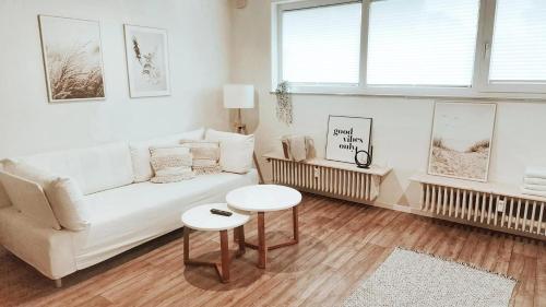 a living room with a white couch and a table at Wohnung in Bremen Blumenthal in Bremen