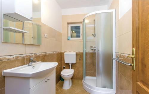 La salle de bains est pourvue de toilettes, d'un lavabo et d'une douche. dans l'établissement Villa Oasis near Krka Waterfalls, à Drniš