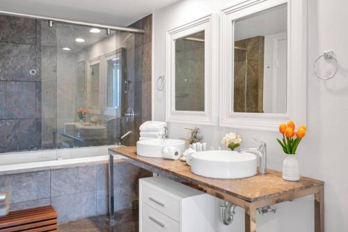 un baño con dos lavabos y una ducha en 38th floor W residence with amenities, en Miami