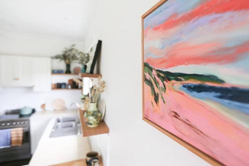 a painting hanging on a wall in a kitchen at Bluey in Warrnambool
