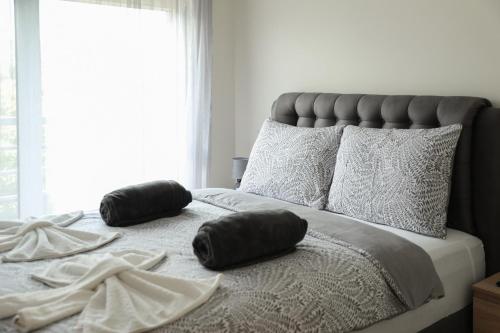 a bed with two pillows sitting on top of it at GOLDEN VIEW Sokobanja in Soko Banja