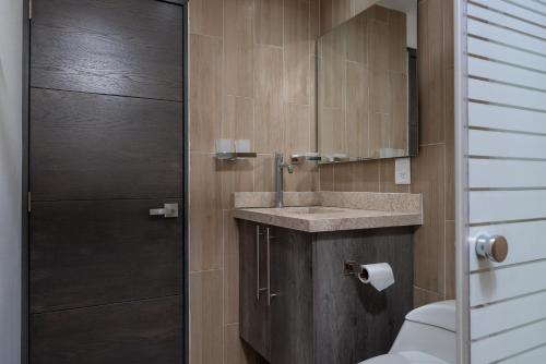 a bathroom with a sink and a toilet at Casa Xtao Hotel in Santa Cruz Huatulco