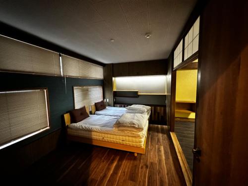 a bedroom with a bed in the middle of it at Artist Village Apartments Kochi in Kochi