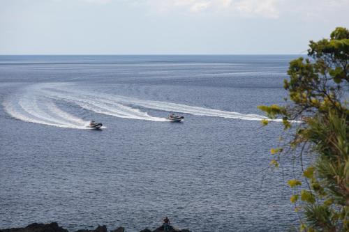 two boats in a body of water at Casas da Pedreira in Lajes do Pico