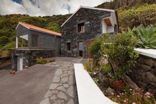 a stone house with a stone driveway at Casas da Pedreira in Lajes do Pico