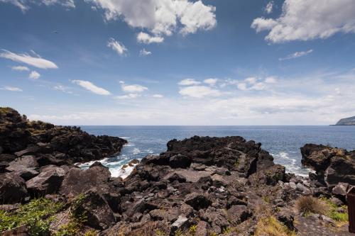 a view of the ocean from a rocky beach at Casas da Pedreira in Lajes do Pico