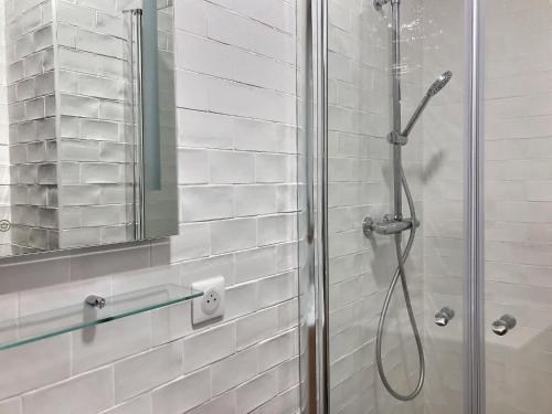a bathroom with a shower with a glass door at L'idéal Mairie de Montreuil in Montreuil