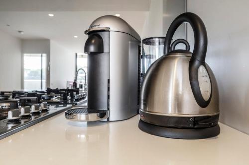 a tea kettle sitting on top of a kitchen counter at Abbotsford Short Stay Luxury Style & Location in Melbourne