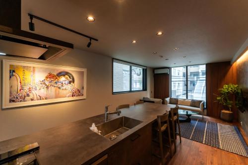 a kitchen with a sink and a living room at Flower Base Fuji in Muromimachi