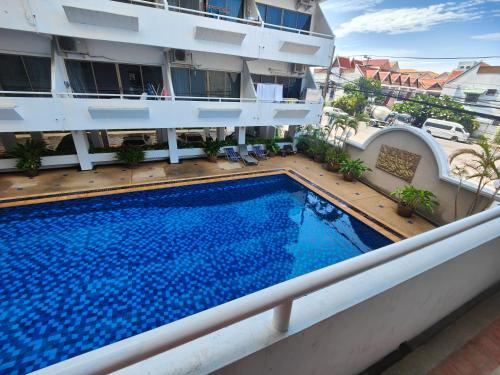 a swimming pool on the balcony of a building at Jomtien Hill Resort Pratamnak in Pattaya South