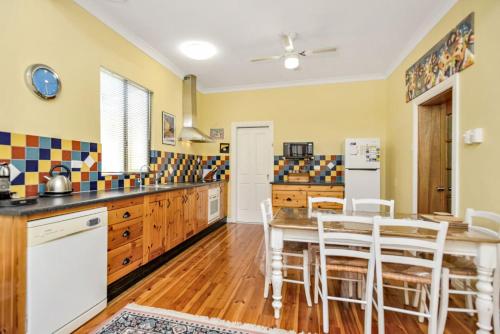 a kitchen with a table and chairs in it at Distant Views Location Pets Welcome in Port Elliot