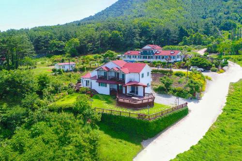 an aerial view of a large house on a river at Travel Sketch Pension in Geoje 